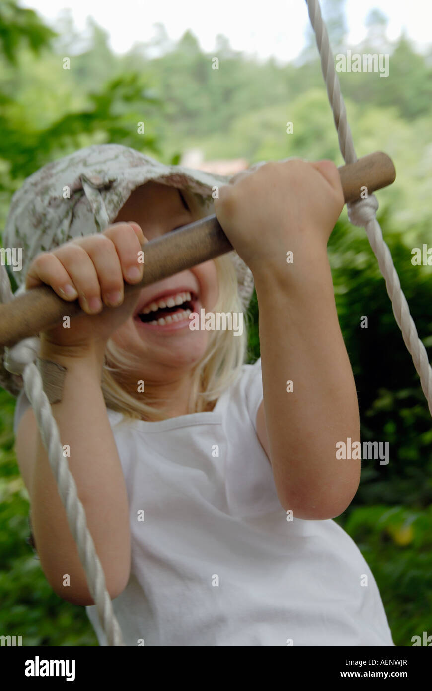 It´s fun to swing. A amused little girl Stock Photo