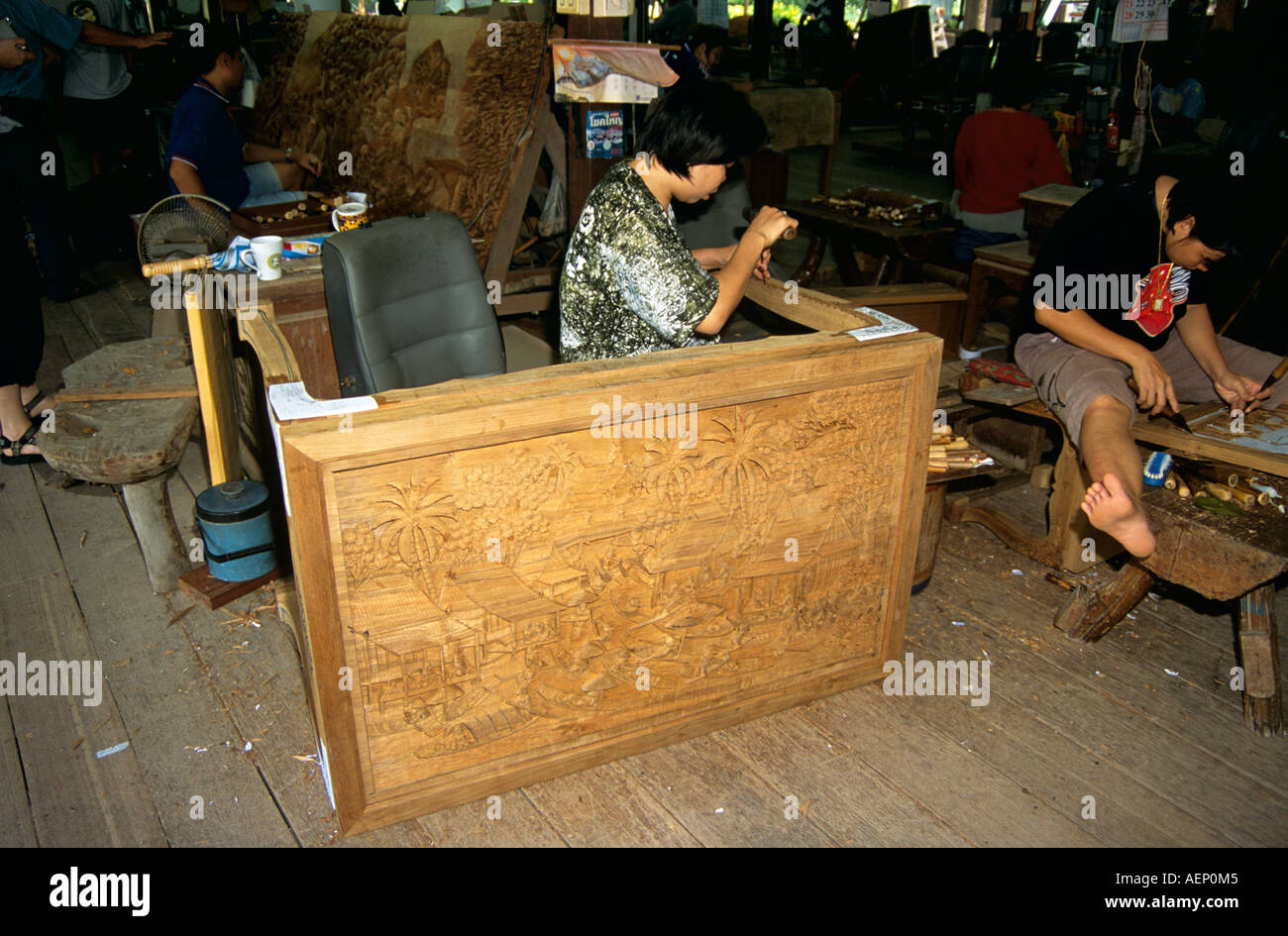 Wood carver working in furniture factory, near Bangkok, Thailand Stock Photo