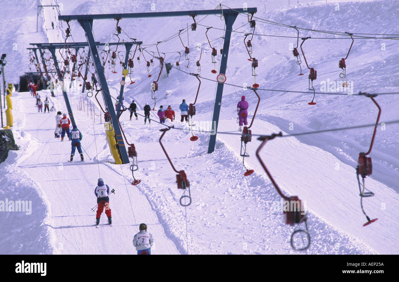 Skiers are pulled up a ski slope by drag lifts at the ski resort of Sestrieres, Italy. Stock Photo
