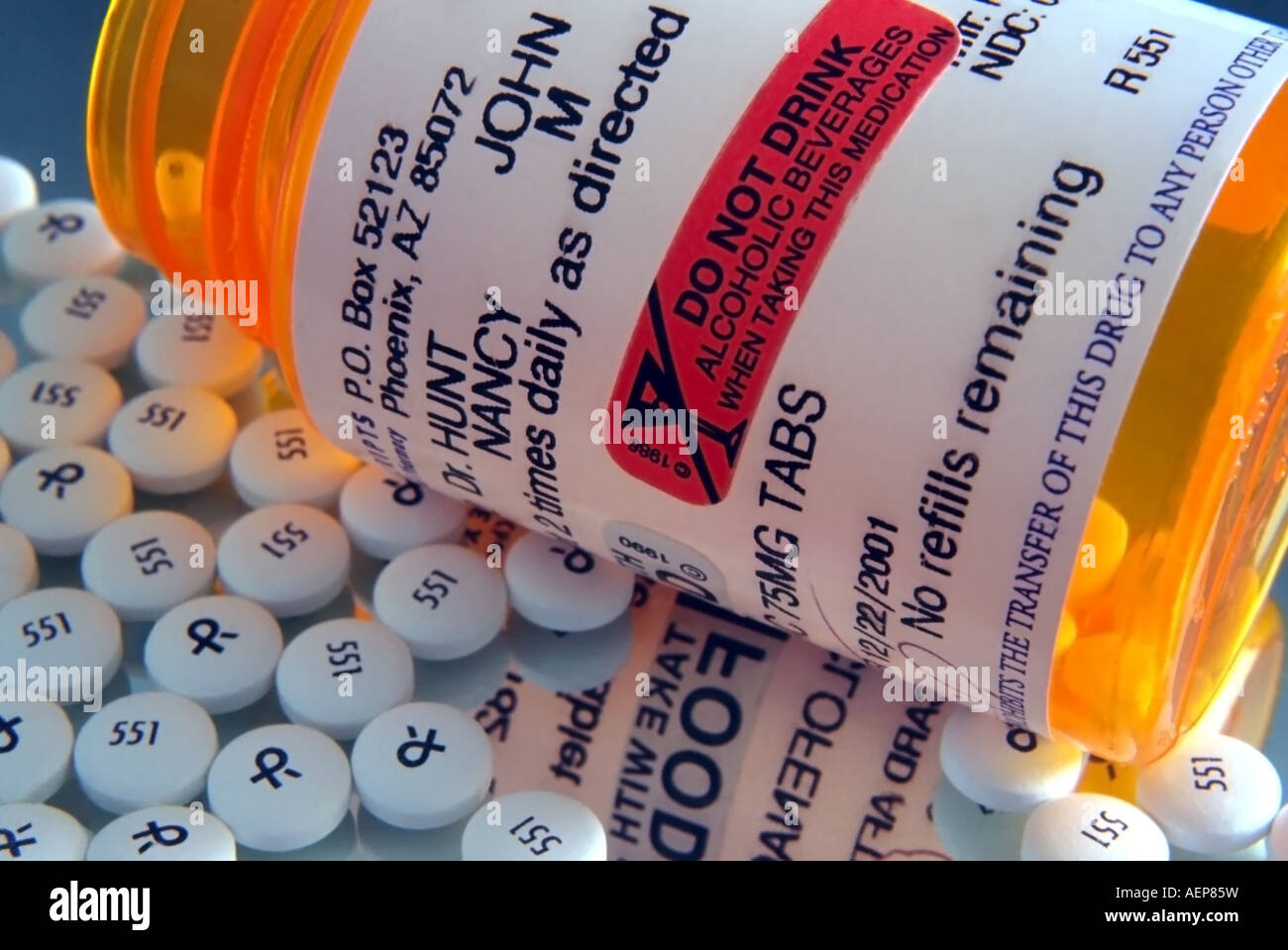 An American prescription bottle laying on its side on a mirror. The ...