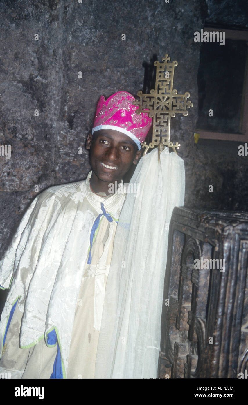 Priest in Bet Danaghel Church holding the Cross of King Lalibela. The  rock-hewn churches of Lalibela make it one of the greatest  Religio-Historical sites not only in Africa but in the Christian