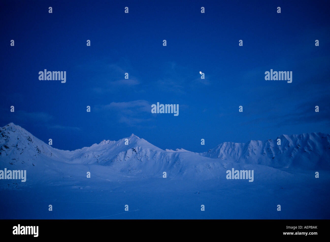 USA Alaska Gibbous moon rises above Talkeetna Range peaks near Hatcher ...
