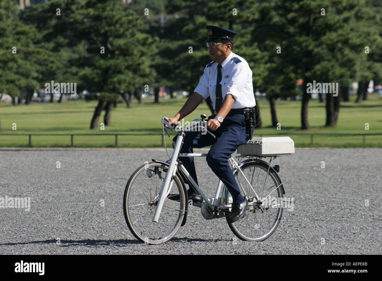 Security Officer cyclist Imperial Palace Gardens Tokyo Japan Stock Photo