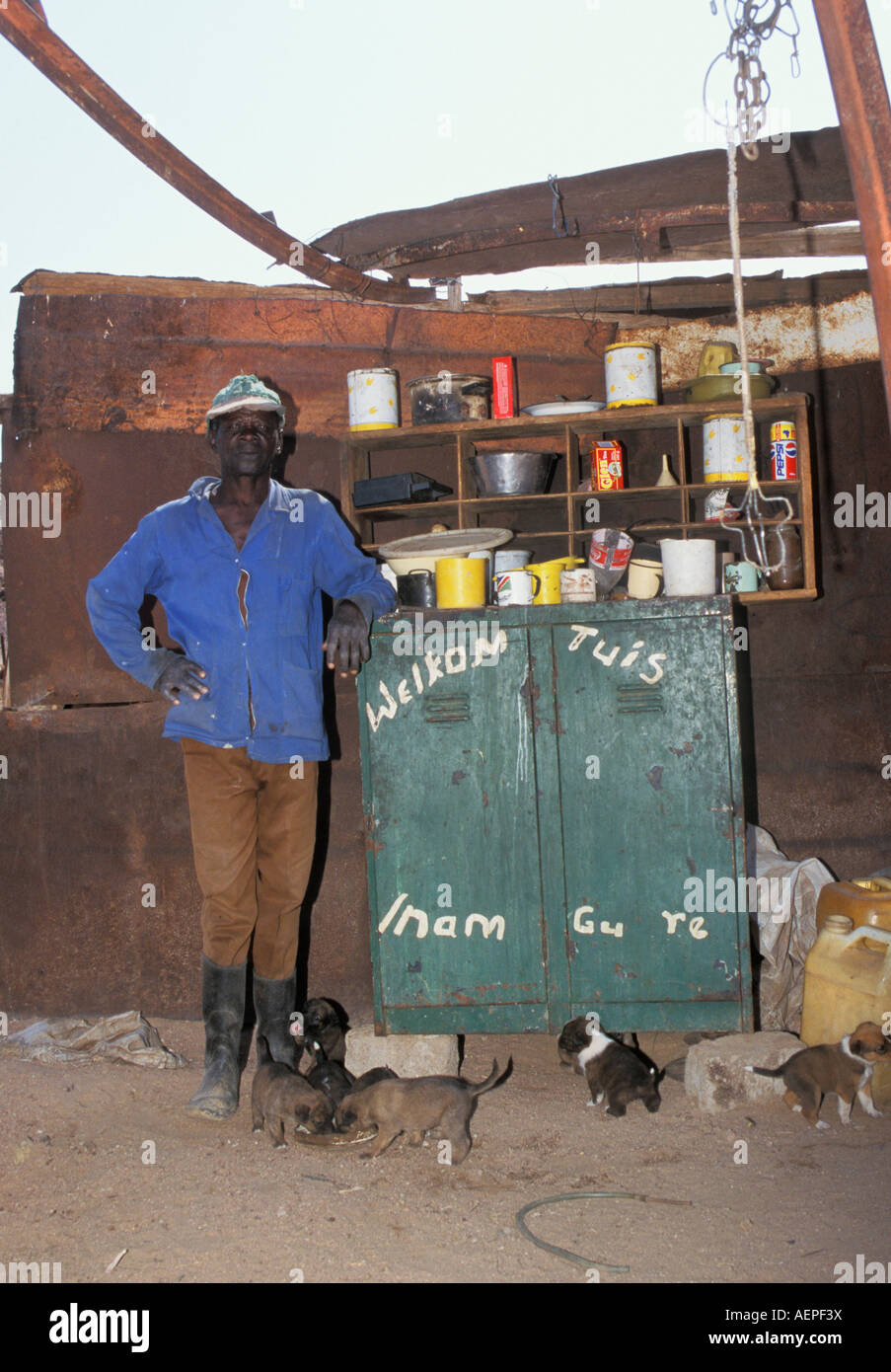 Namibia Swakopmund Namib Desert: Man of Topnaar tribe standing by cupboard Stock Photo