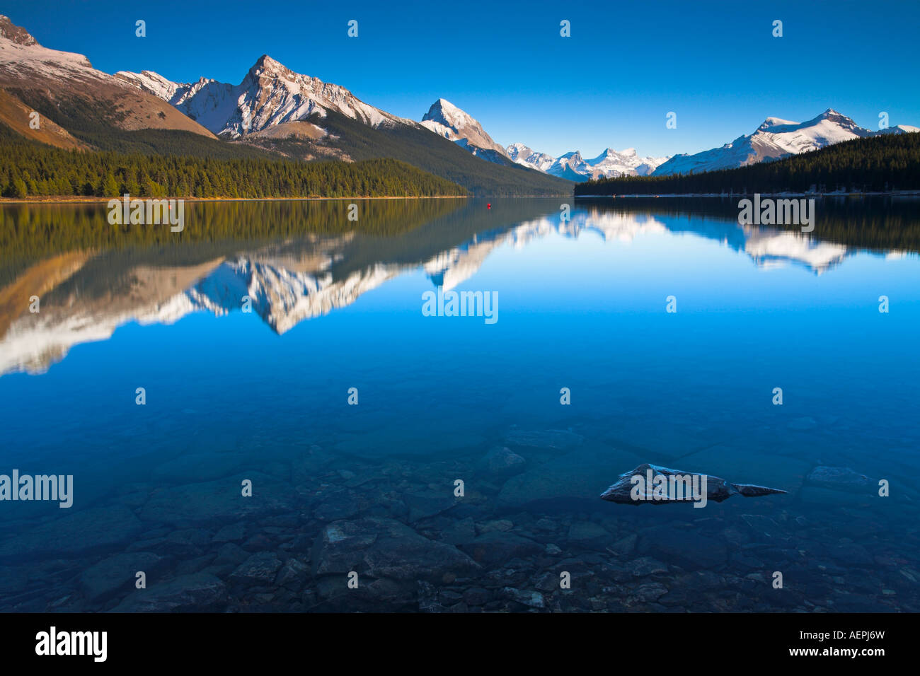 Perfectly Still Crystal Clear Waters Of Maligne Lake Jasper