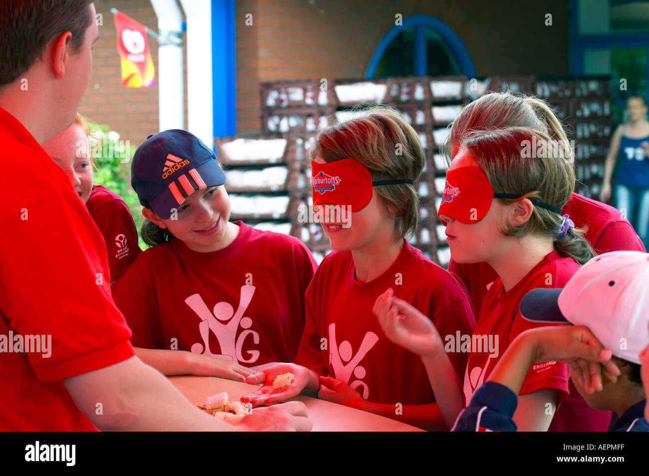 young girls taste testing bread at a sports event Stock Photo