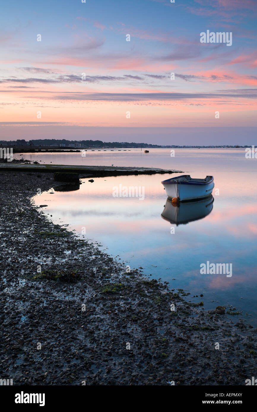 Small boat in Poole Harbour at dawn Stock Photo