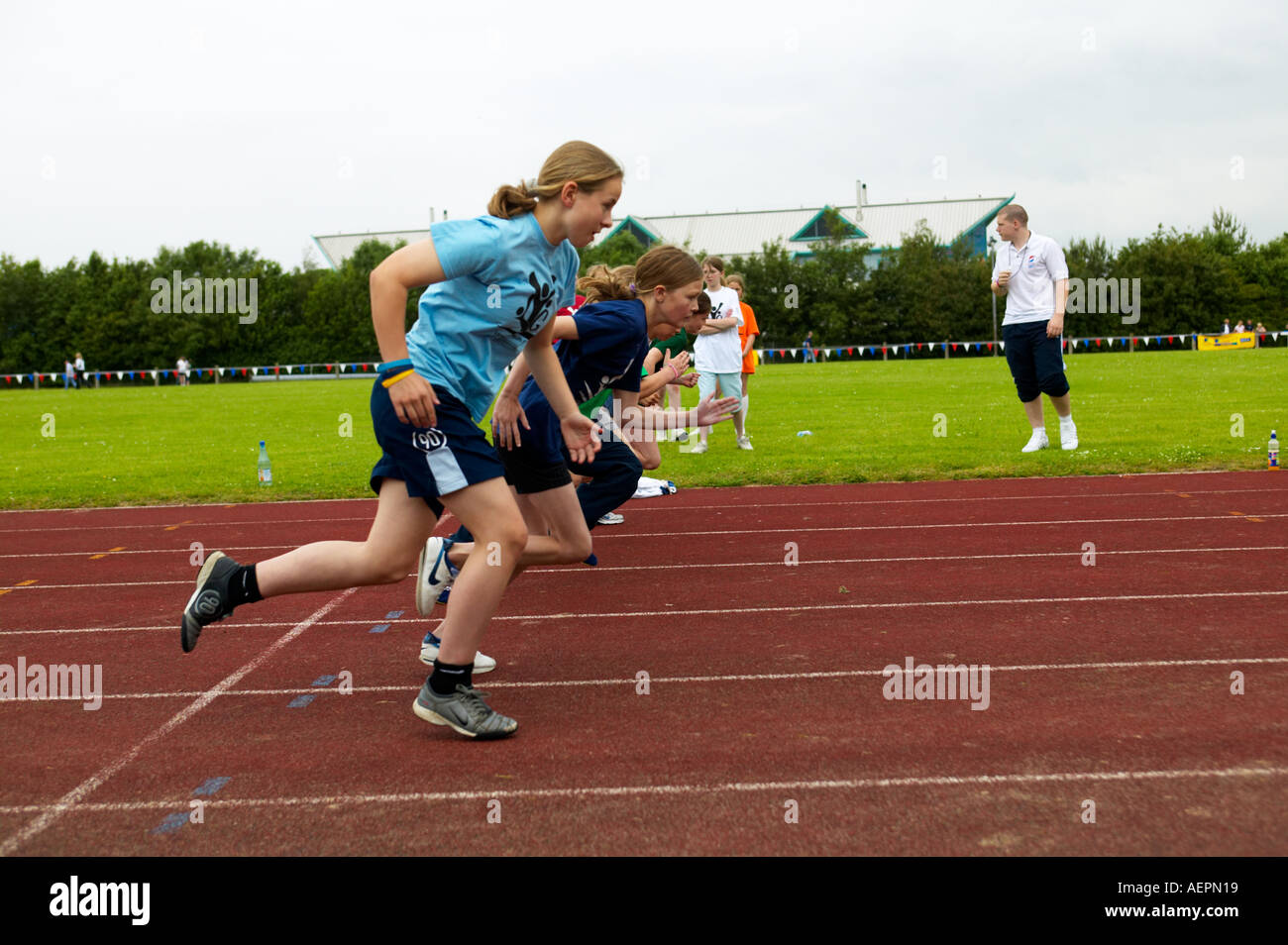 girls competing in running race at sports day event Stock Photo