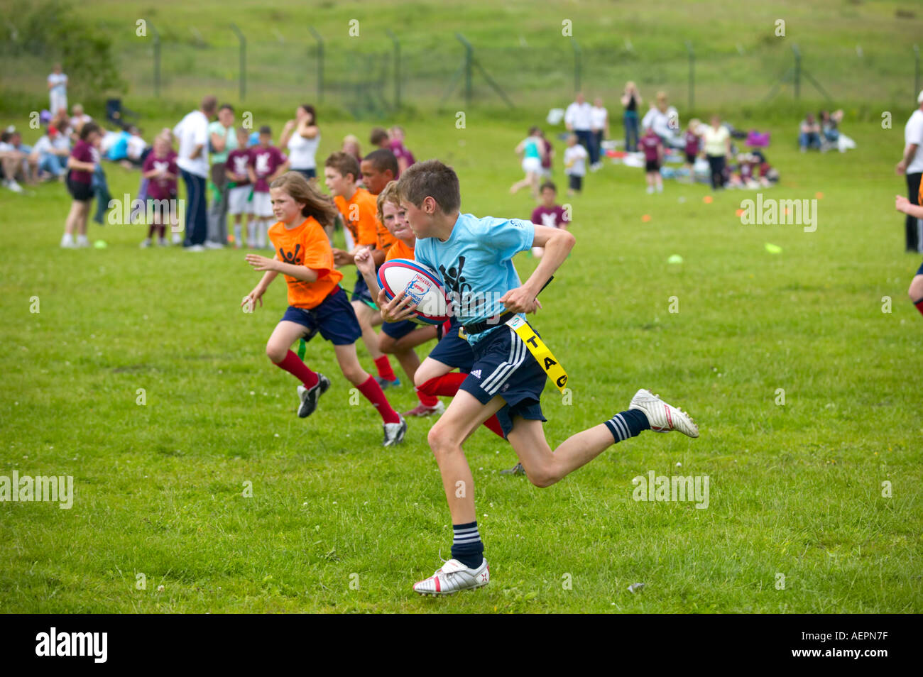 youngsters playing rugby football at sports day event Stock Photo