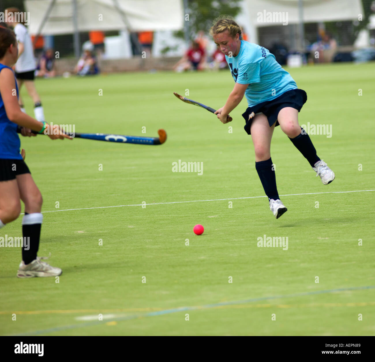 girls playing hockey at sports day event Stock Photo