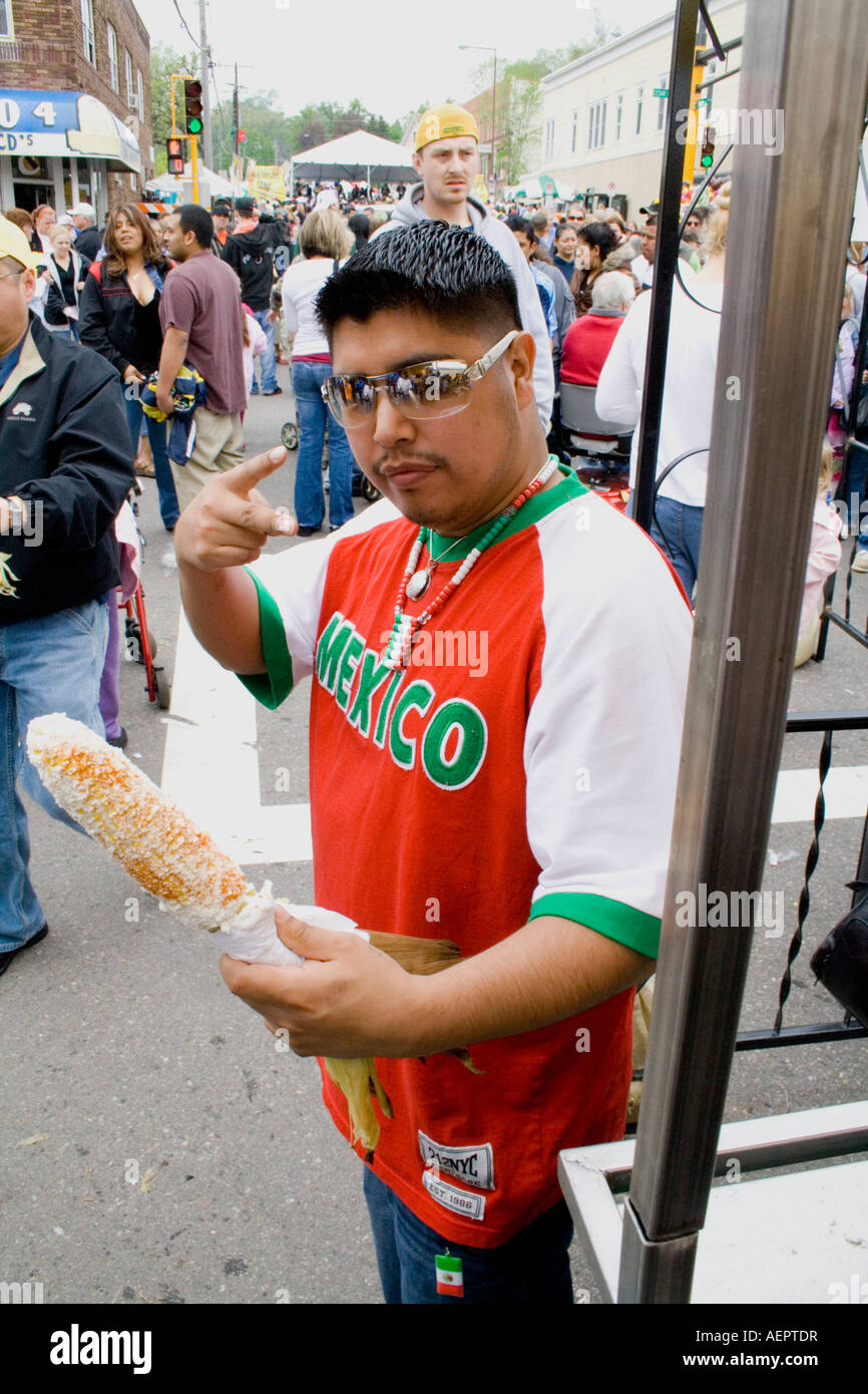 Chicano man age 19 signaling that he is enjoying freshly roasted corn ...