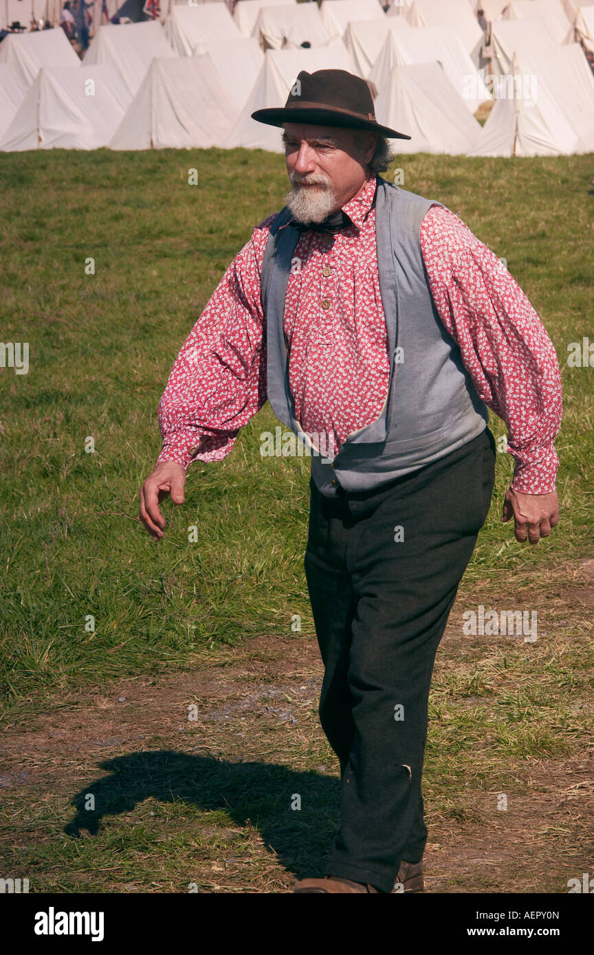 A civilian senior reenactor walks across the Confederate encampment Stock Photo