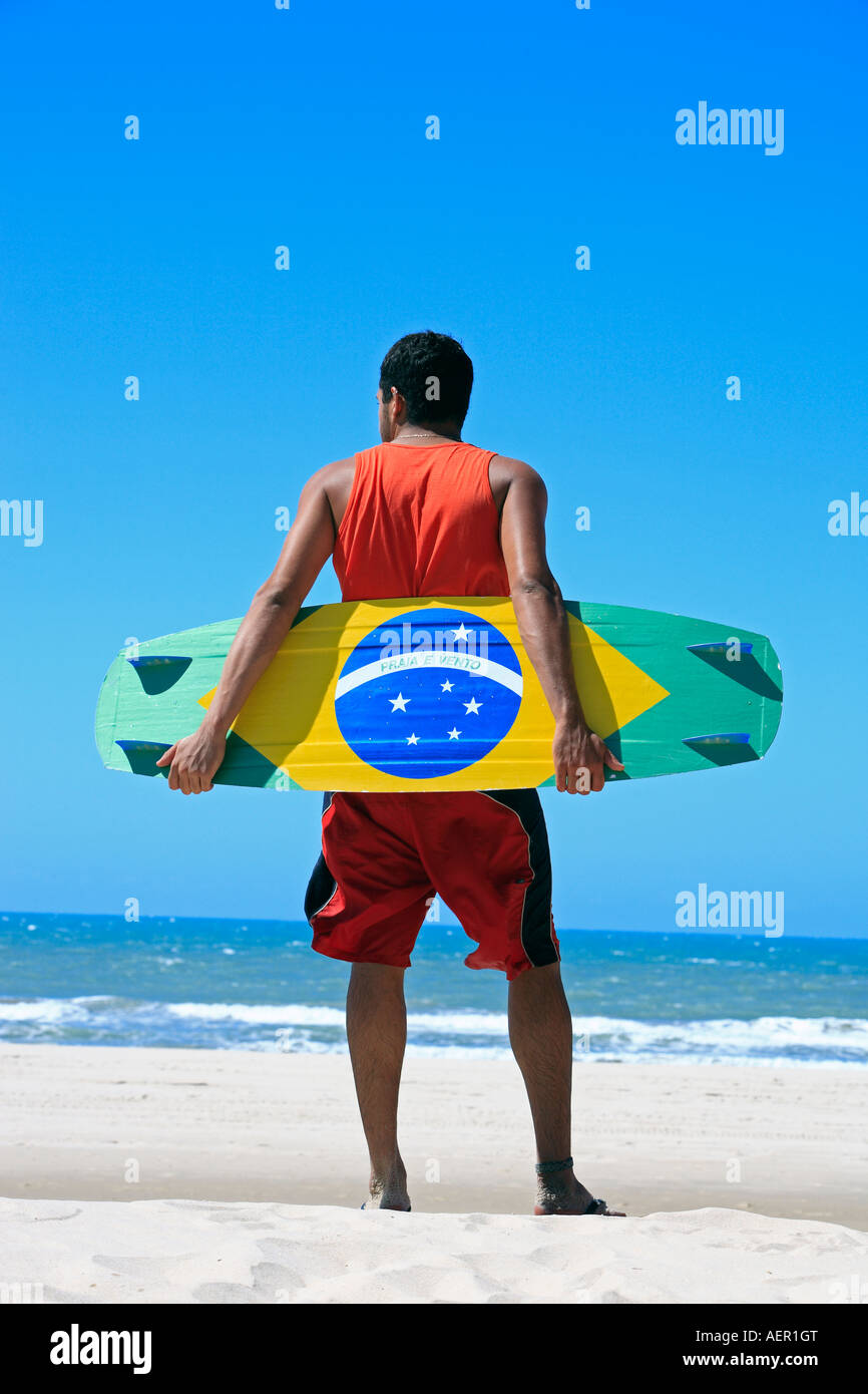 Kite surfer with the brazilian flag painted on the board with "praia e