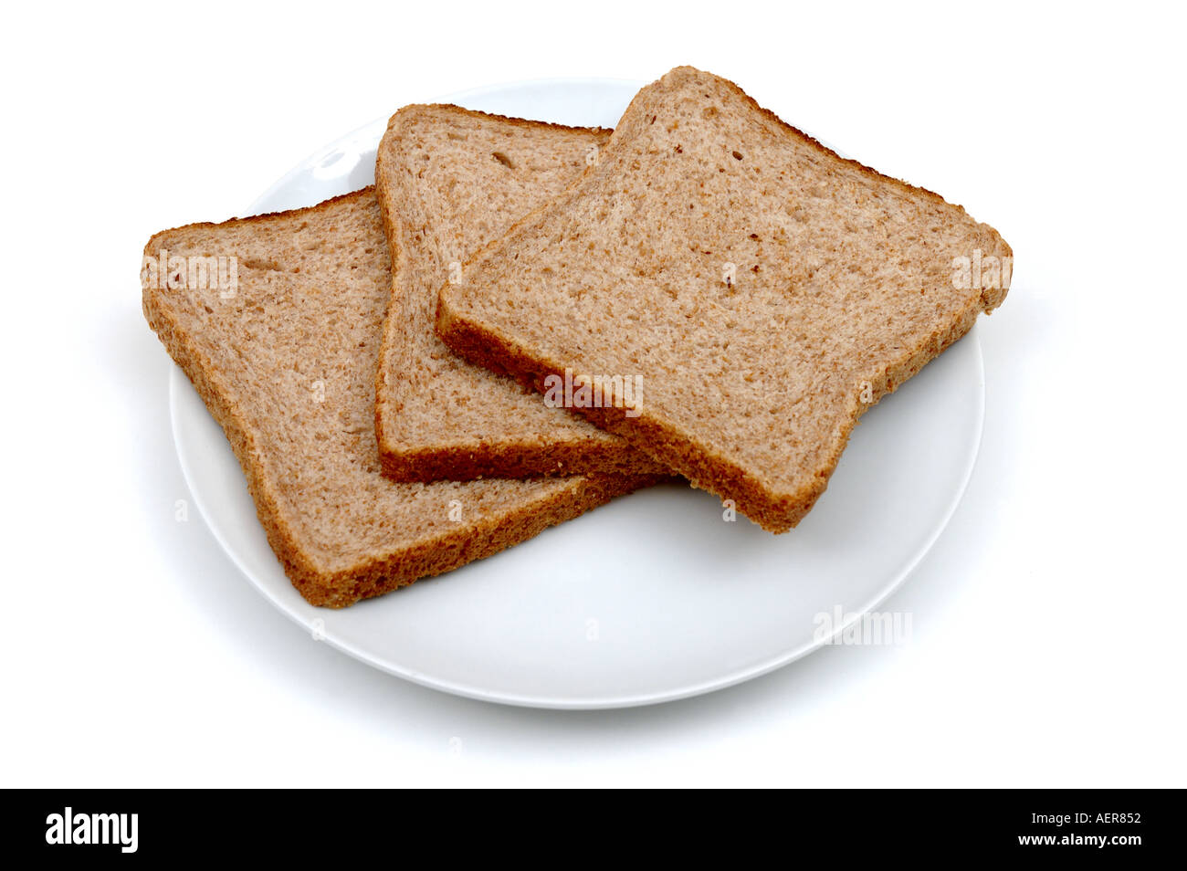 Three slices of wholemeal bread on a ceramic plate Stock Photo 2553937