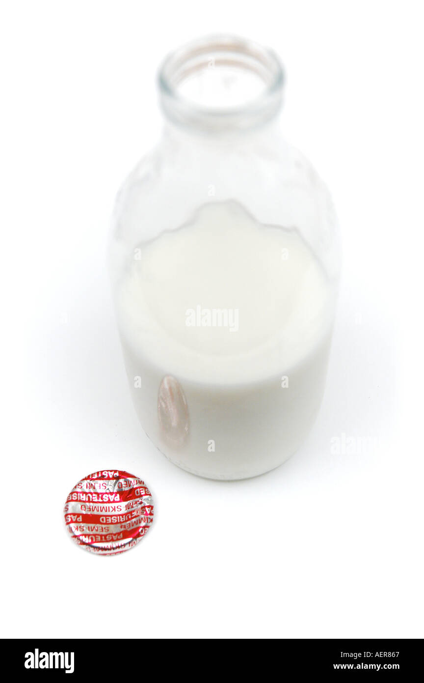 Half full semi skimmed milk bottle with pressed aluminium foil cap Stock Photo