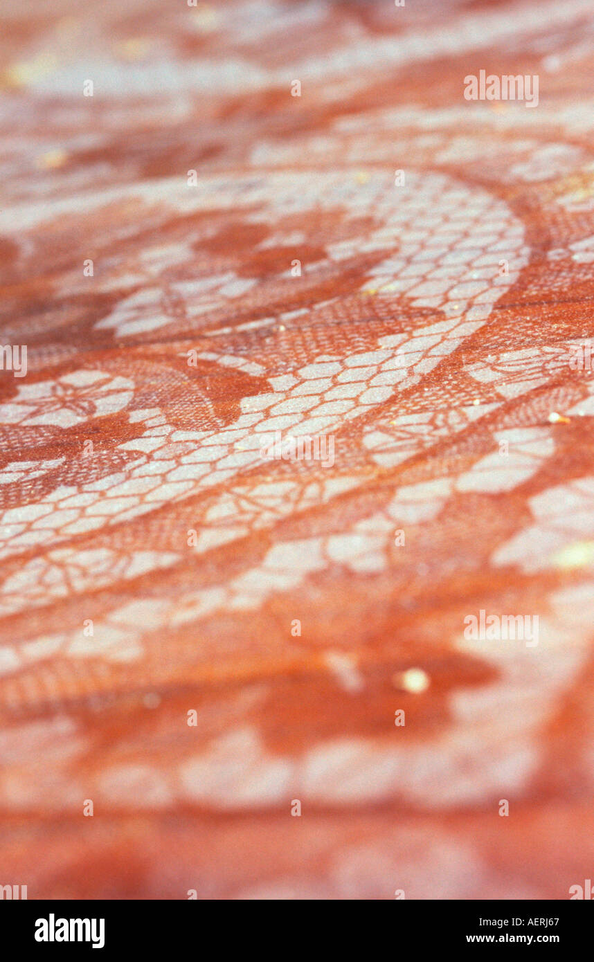 The dust pattern left on a wood table under a lace tablecloth. Stock Photo