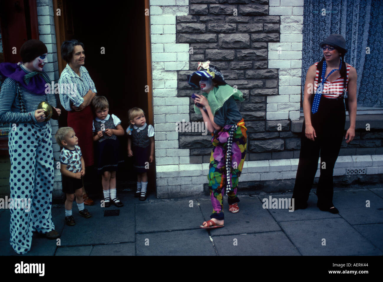 Clown summer school Cardiff Wales. Poor deprived children learn to act like a clown on the street performing street theatre 1980s UK HOMER SYKES Stock Photo