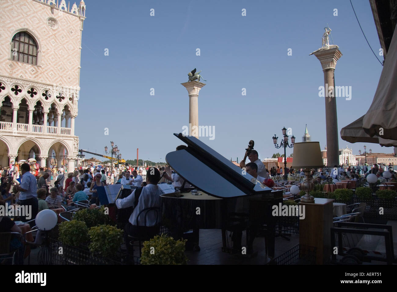 Musicians at the Gran Cafe Chioggia across from the Doges Palace beneath the Columns of San Marco and San Teodoro Venice Italy Stock Photo