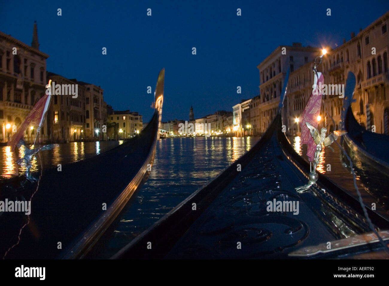 Group of gondolas on the Grand Canal at night with the Rialto Bridge in ...