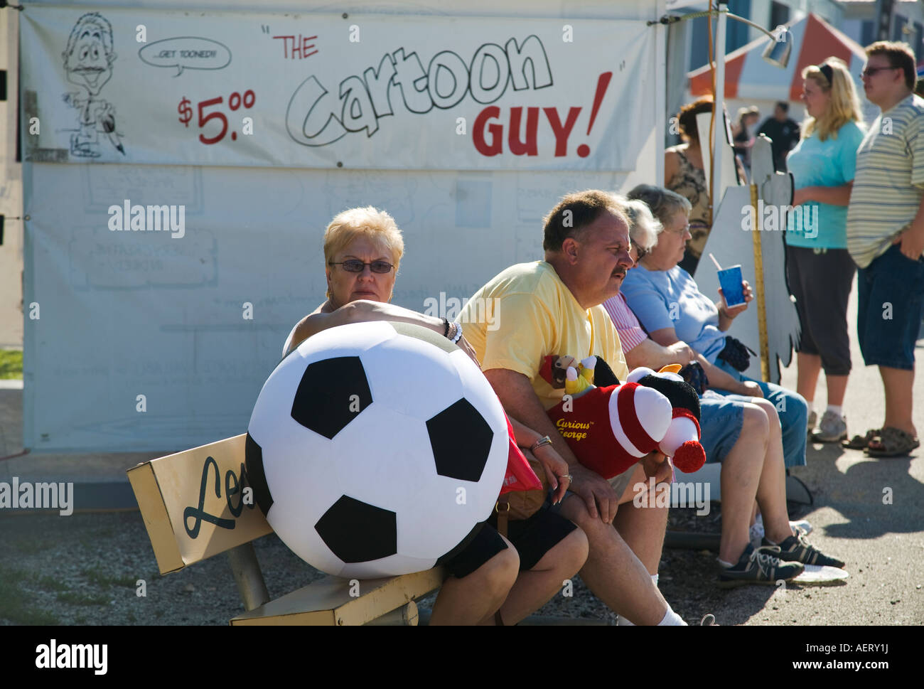 ILLINOIS Grayslake Woman sit bench hold large stuffed soccer ball man