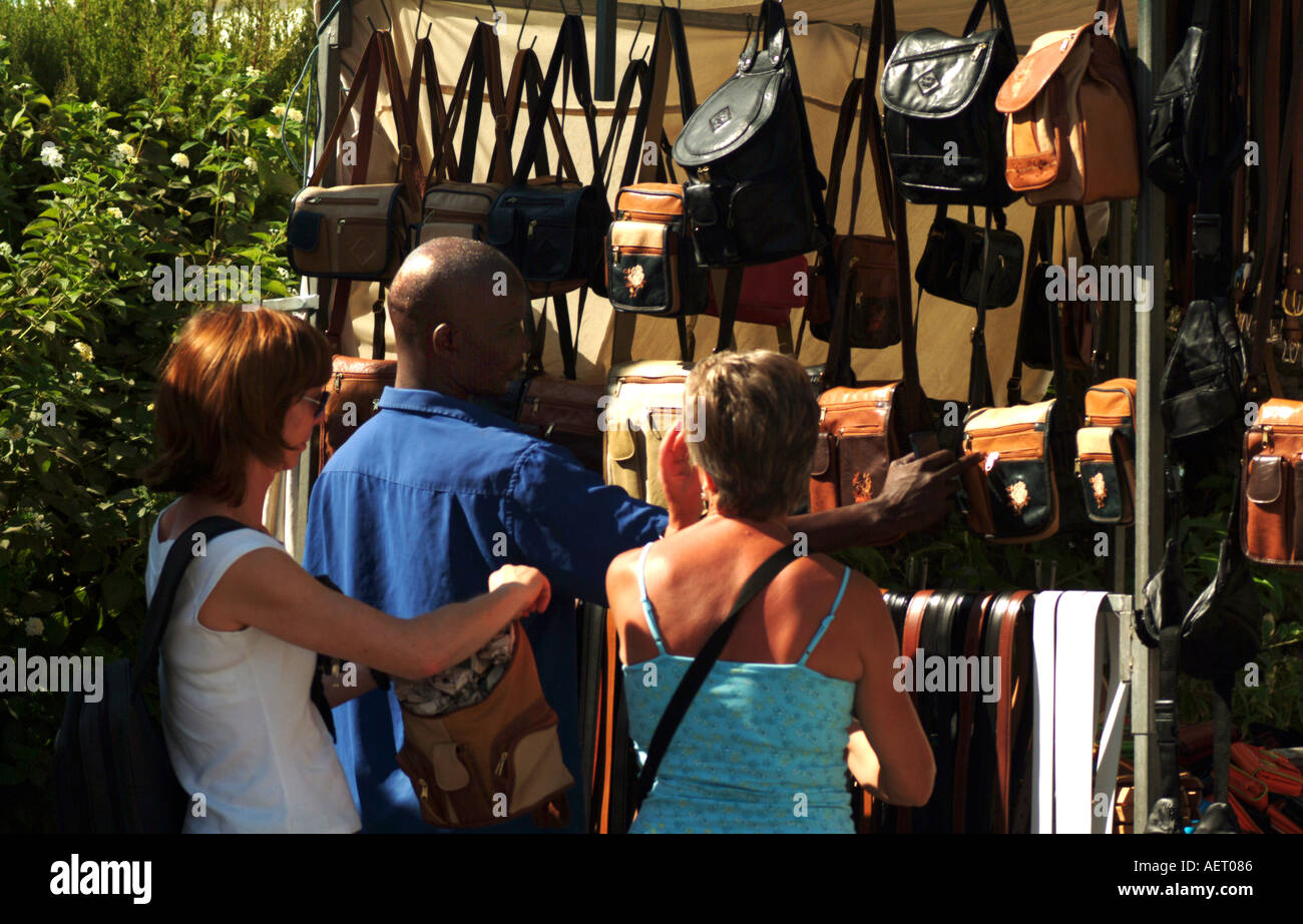 Tourists at roadside buying leather handbags Torrevieja Spain Spain Stock Photo