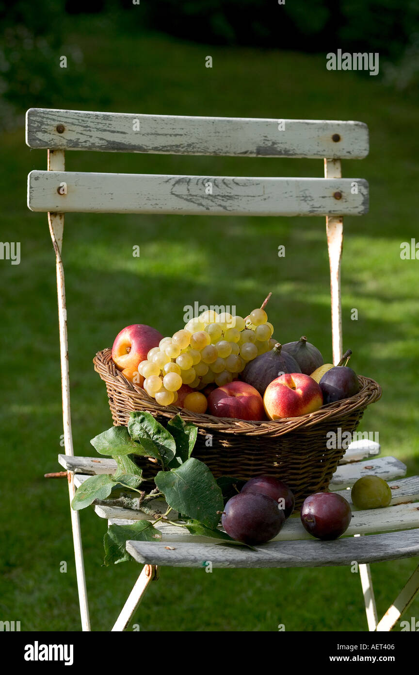 SEASONAL STILL LIFE WITH AN ASSORTMENT OF AUTUMNAL FRUITS IN A WICKER ...