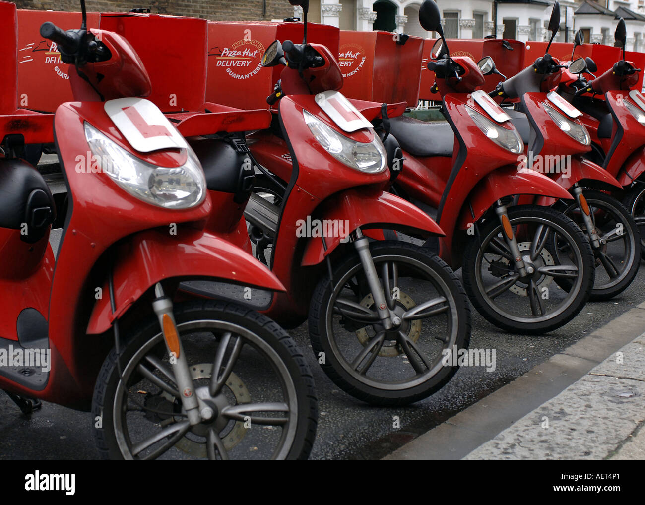 A Line Of Pizza Hut Delivery Bikes Parked In Street Fulham London A Line Of Pizza Hut Delivery Bikes Parked In Street Fulham London