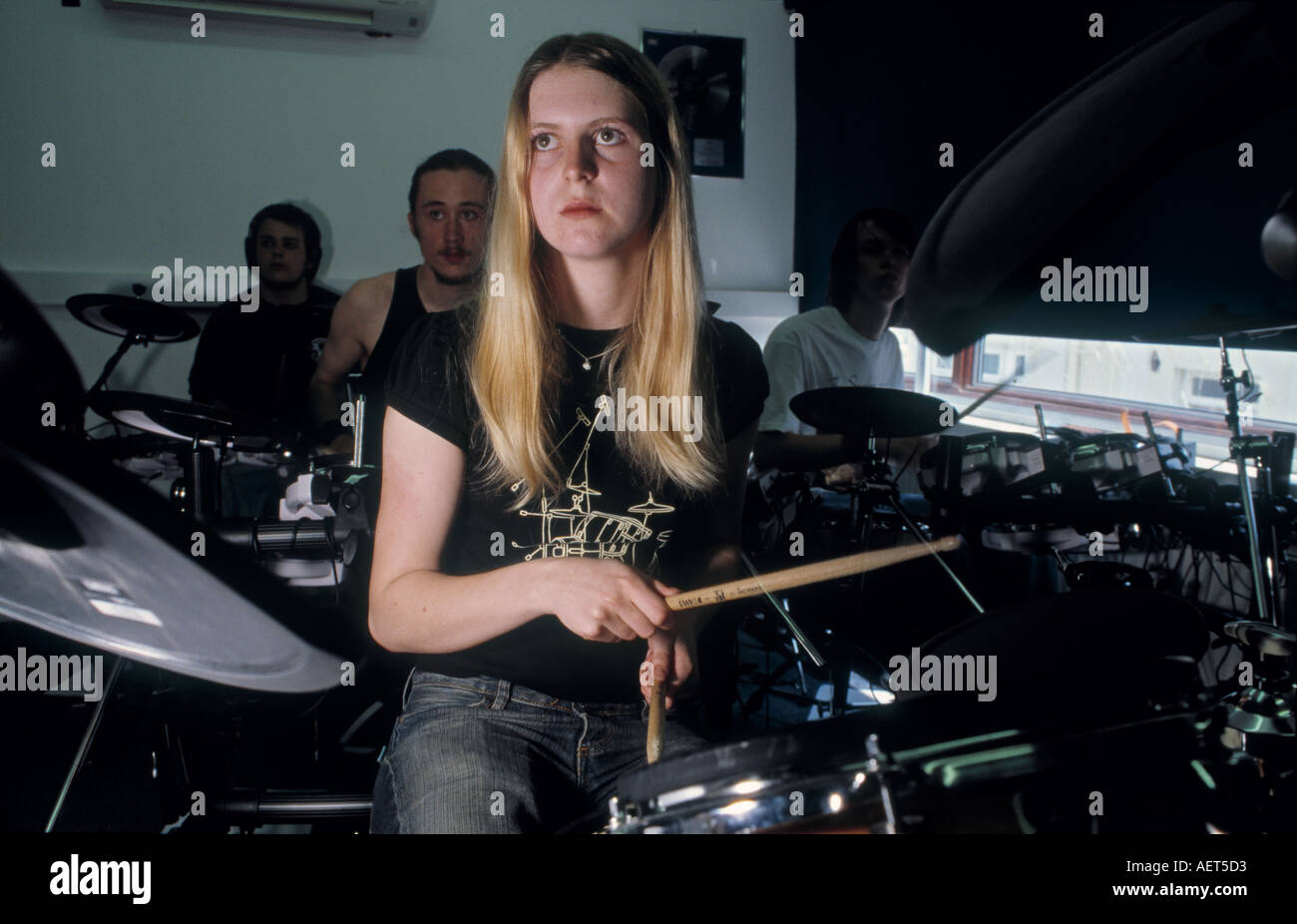 FEMALE GIRL STUDENT PLAYING DRUMS AT THE  BRIGHTON INSTITUTE OF MODERN MUSIC. ROCK SCHOOL Stock Photo