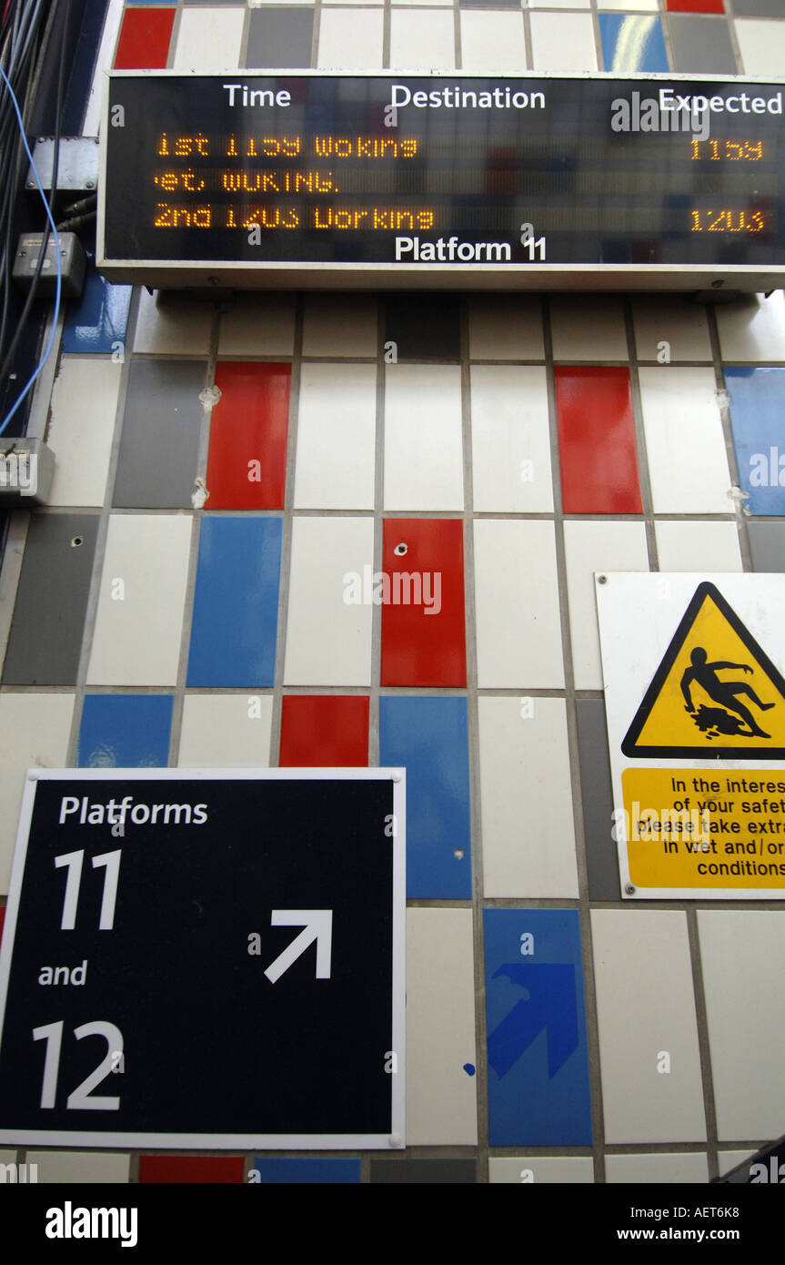 Trains going to Woking are advertised at Clapham Junction station