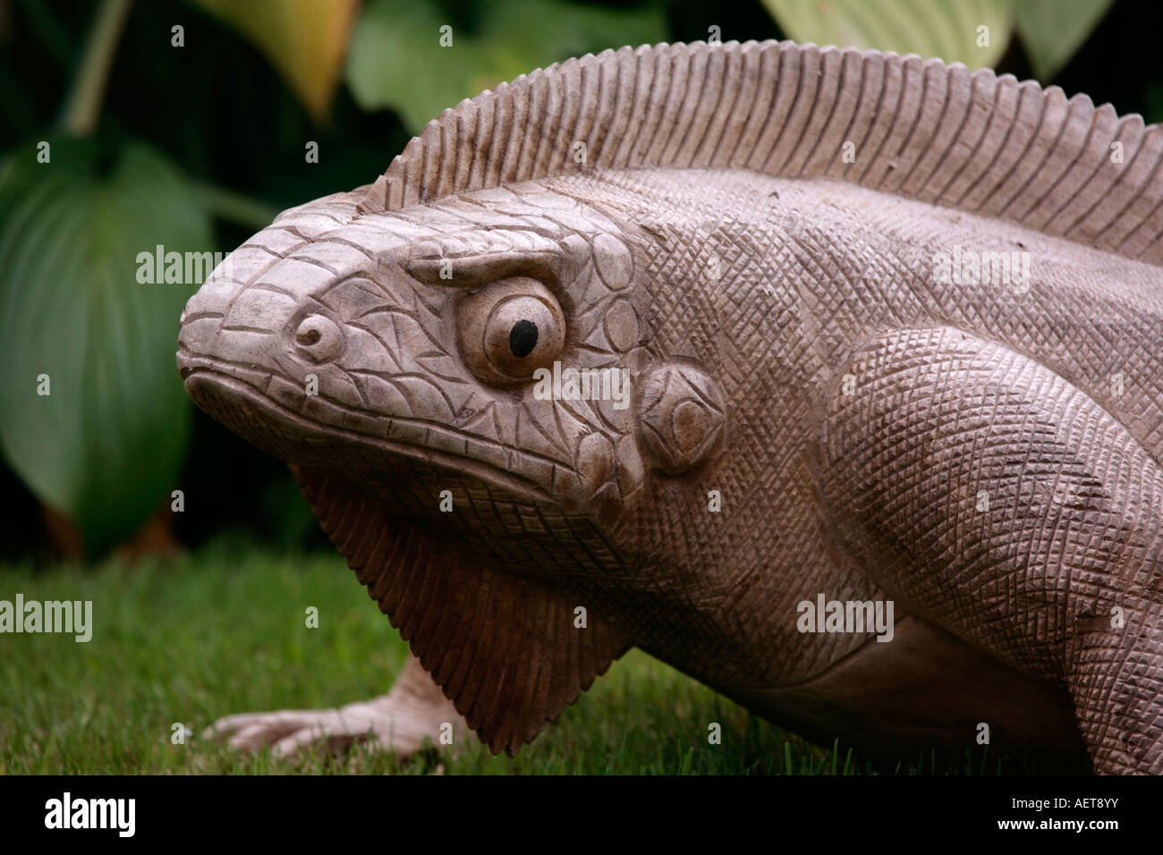 Large carved wooden garden ornament in the shape of a Crested Lizard Stock Photo Alamy