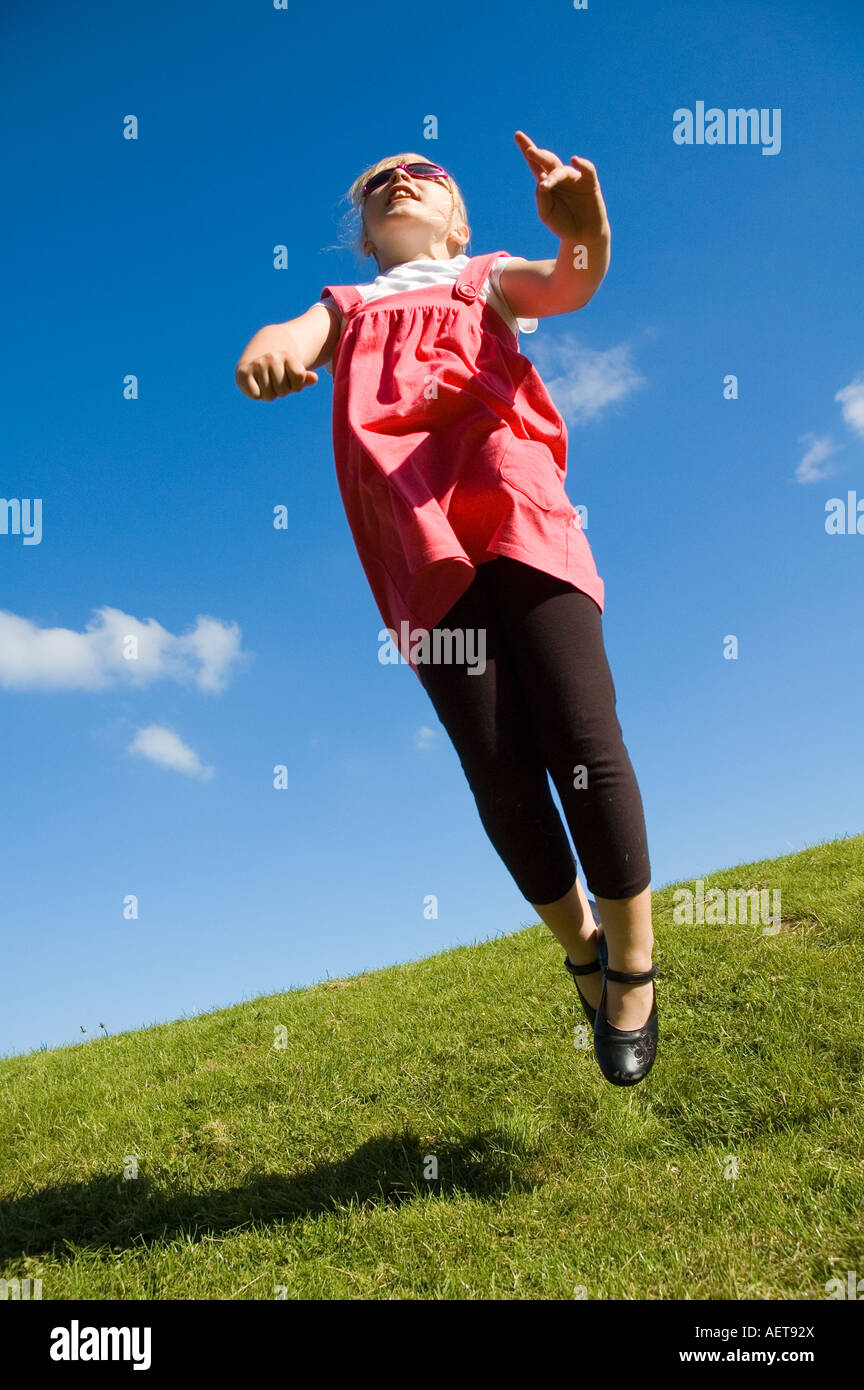 Child jumping hands air hi-res stock photography and images - Alamy