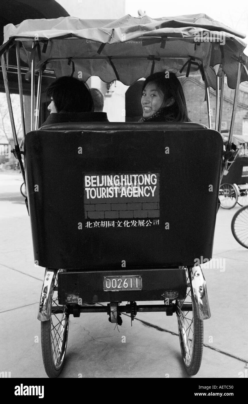 Japanese schoolgirls on a rickshaw tour of Beijing hutongs 2003 China Stock Photo