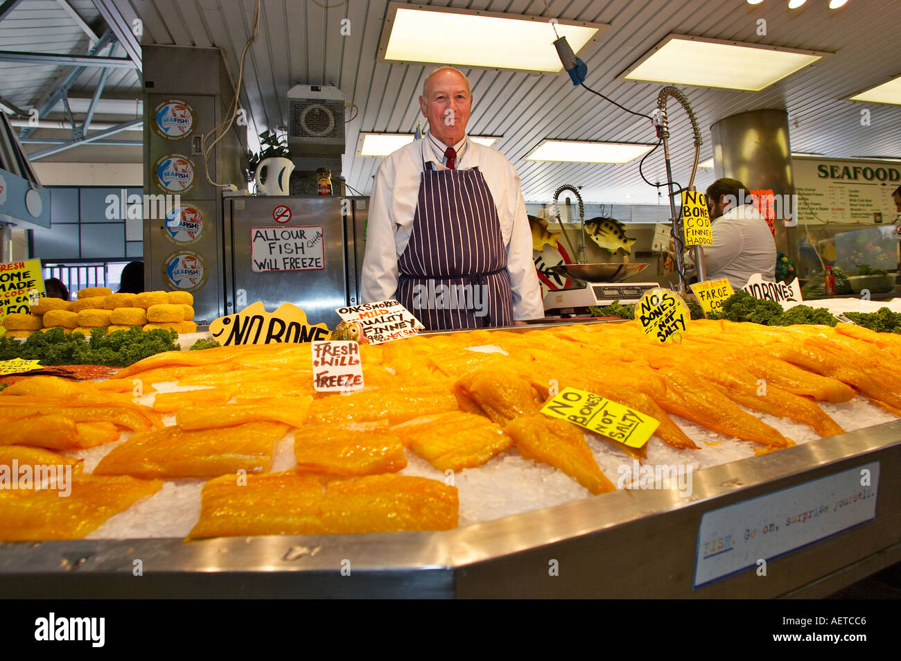 Market trader at his stall selling fresh fish England UK Stock Photo