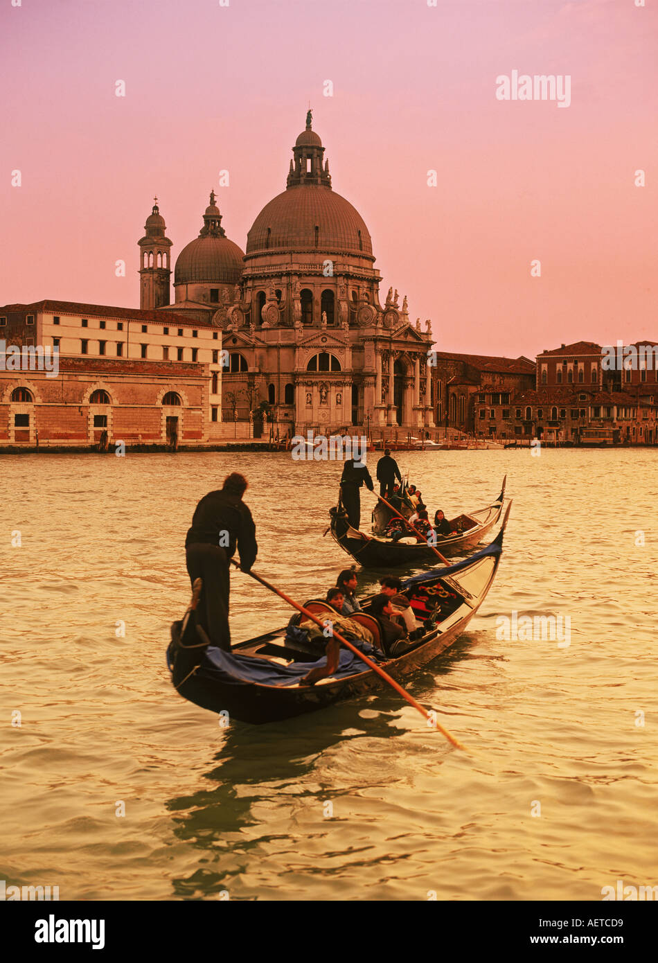 Gondola with Santa Maria della Salute in Venice at sunset Stock Photo