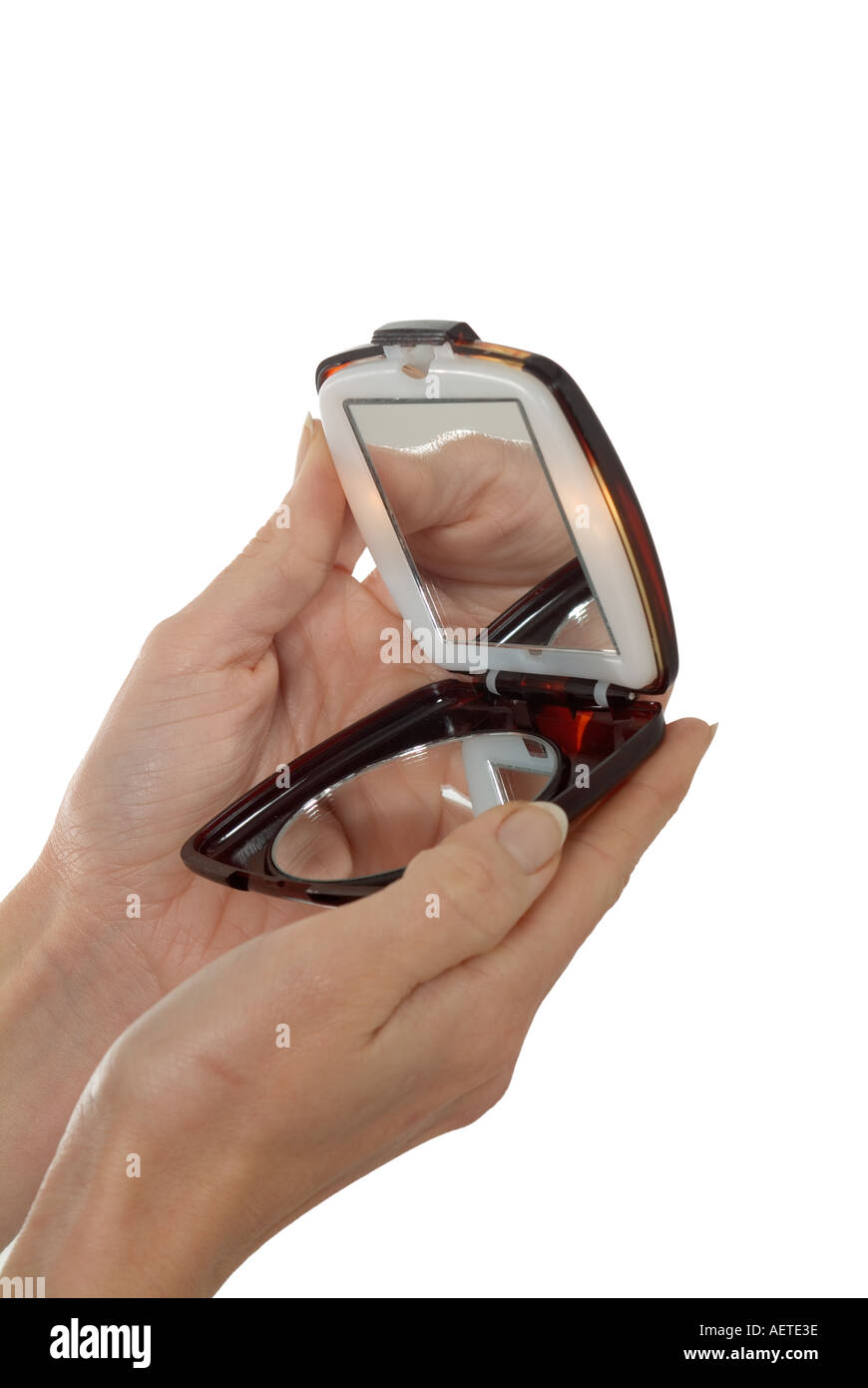 woman opening a mirrored compact case Stock Photo
