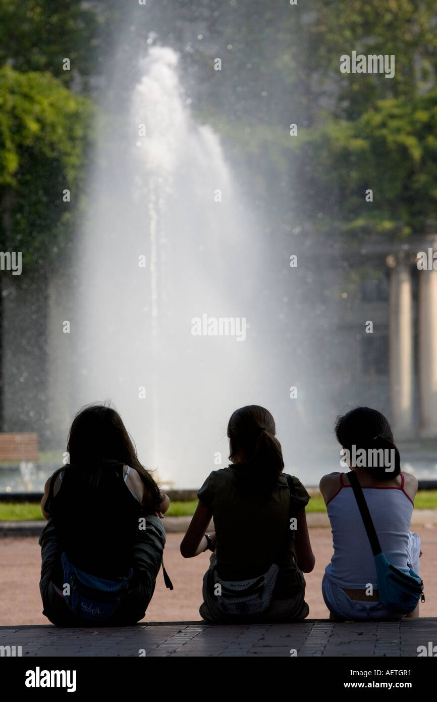 Three young girls watching fountain in Dona Casilda Iturrizar Park Bilbao Stock Photo