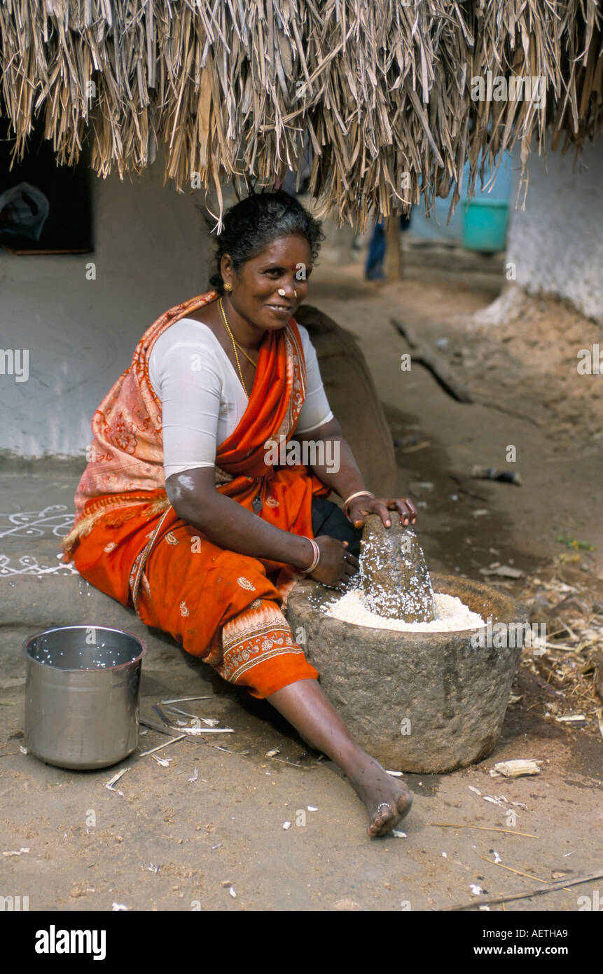 Village woman pounding rice Tamil Nadu India Asia Stock Photo