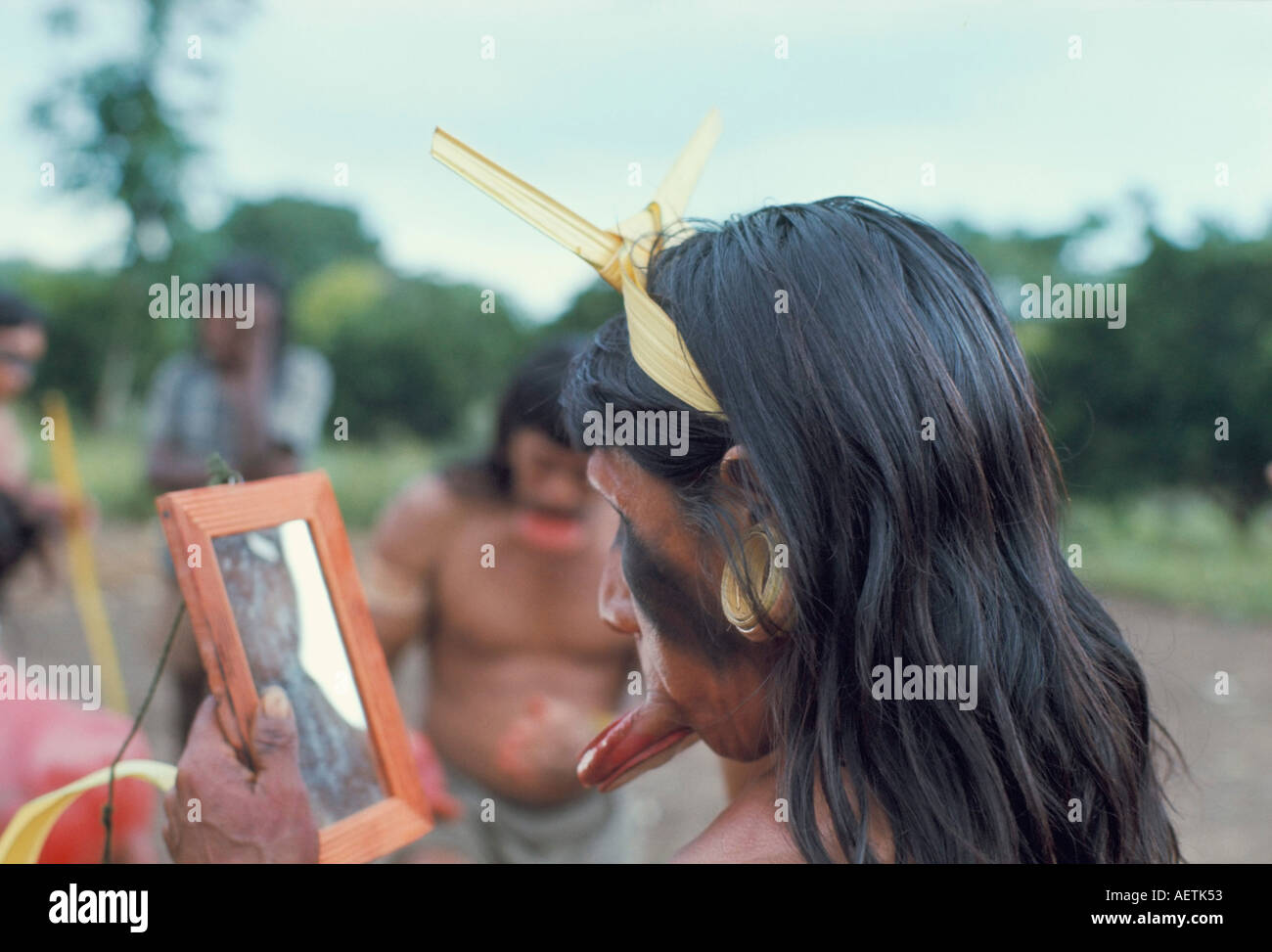 Suya Indian admiring lip disk in mirror Brazil South America Stock Photo