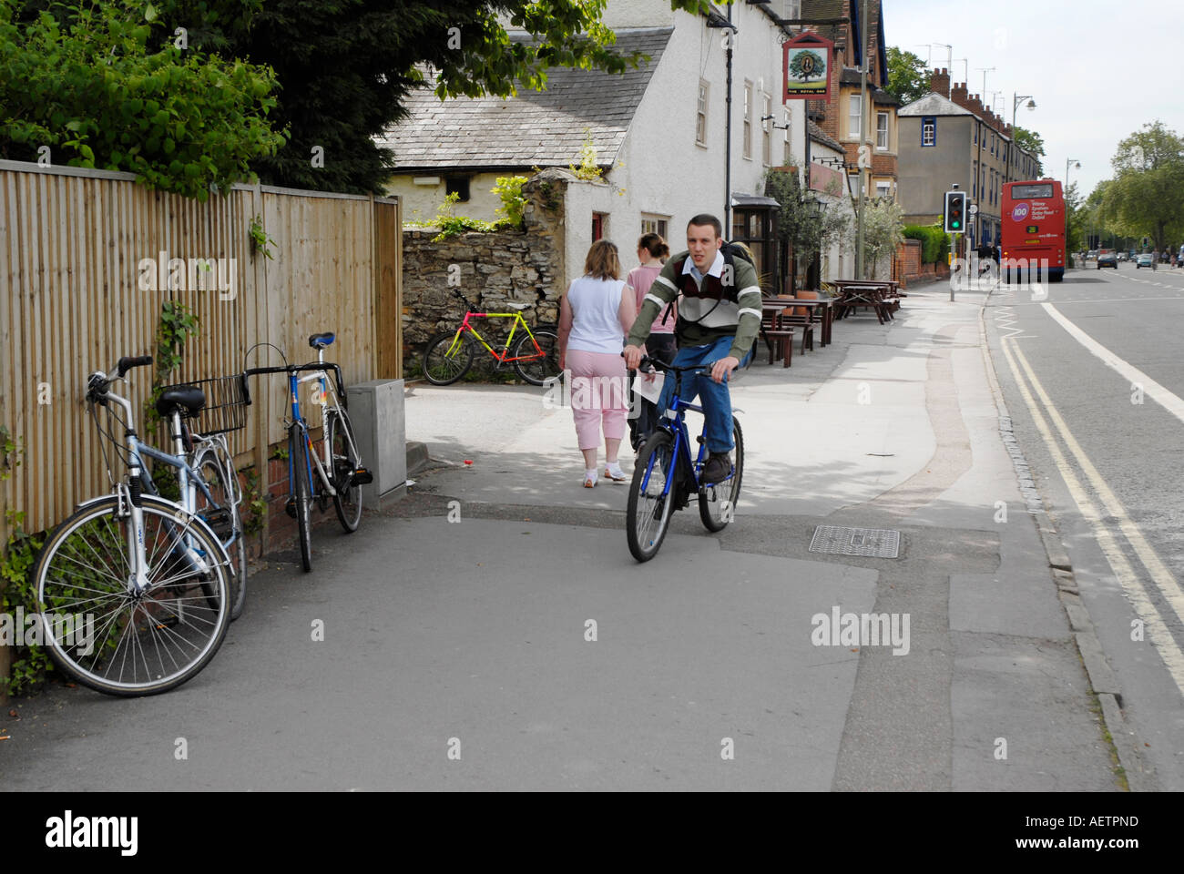 Cyclist riding pedal cycle on the pavement in Woodstock road Oxford