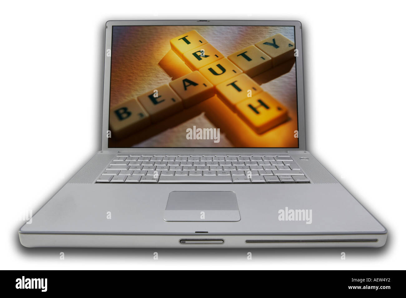 LAP TOP COMPUTER WITH SCRABBLE LETTERS ON SCREEN SPELLING WORDS TRUTH BEAUTY Stock Photo