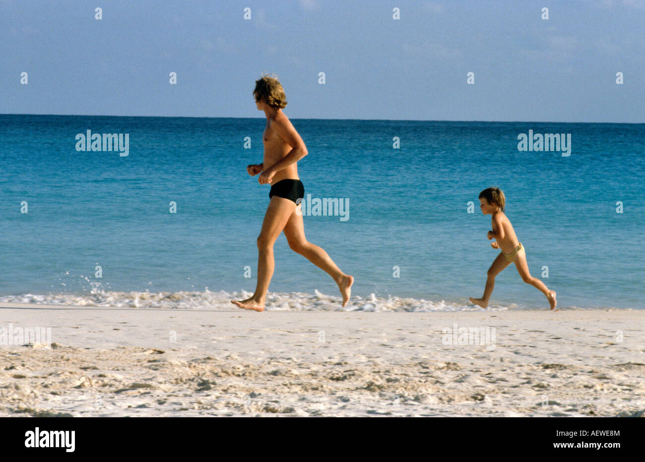 Father And Son Running Along The Beach Bermuda Caribbean Stock Photo