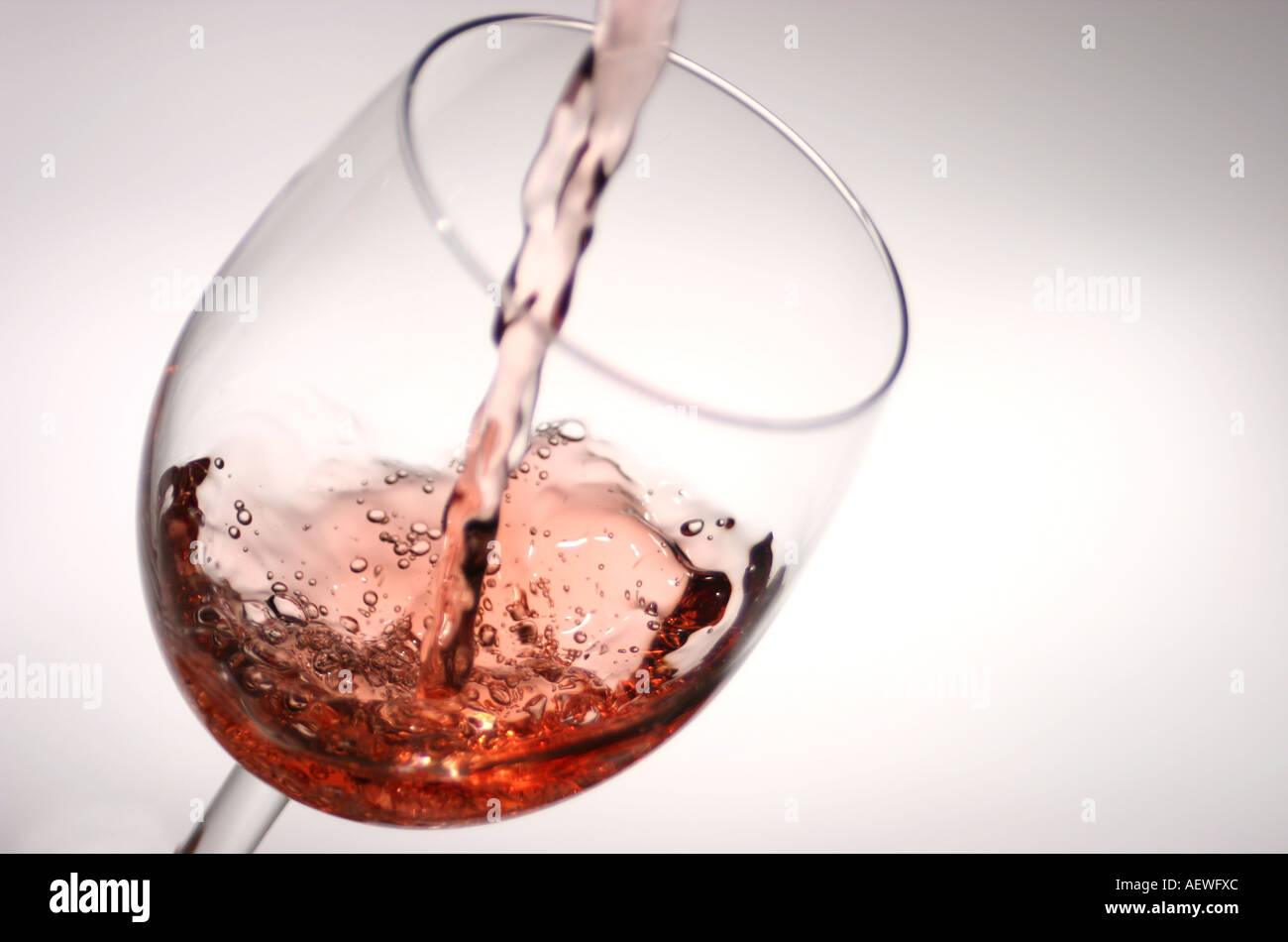 Wine Glass splash pouring Rose Stock Photo - Alamy