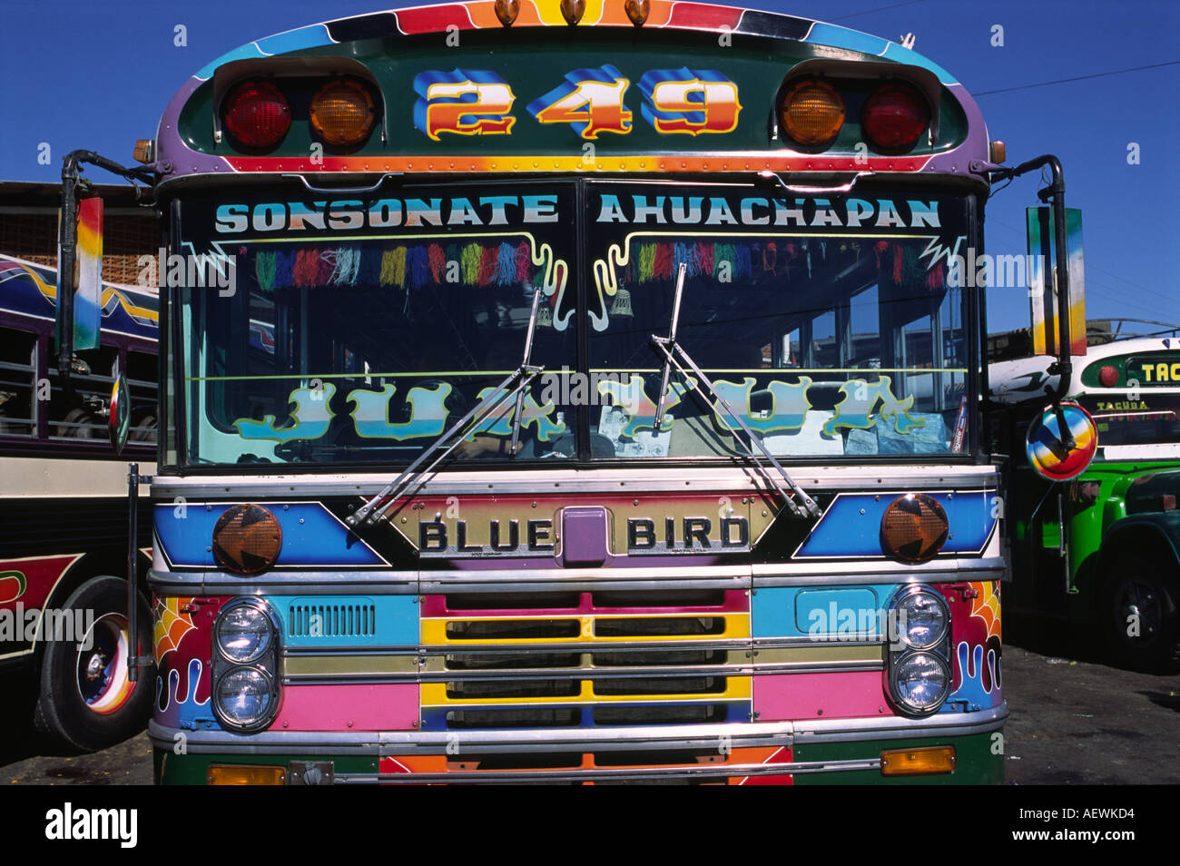 A brightly painted Blue Bird bus in Ahuachapan bus station El Salvador Stock Photo