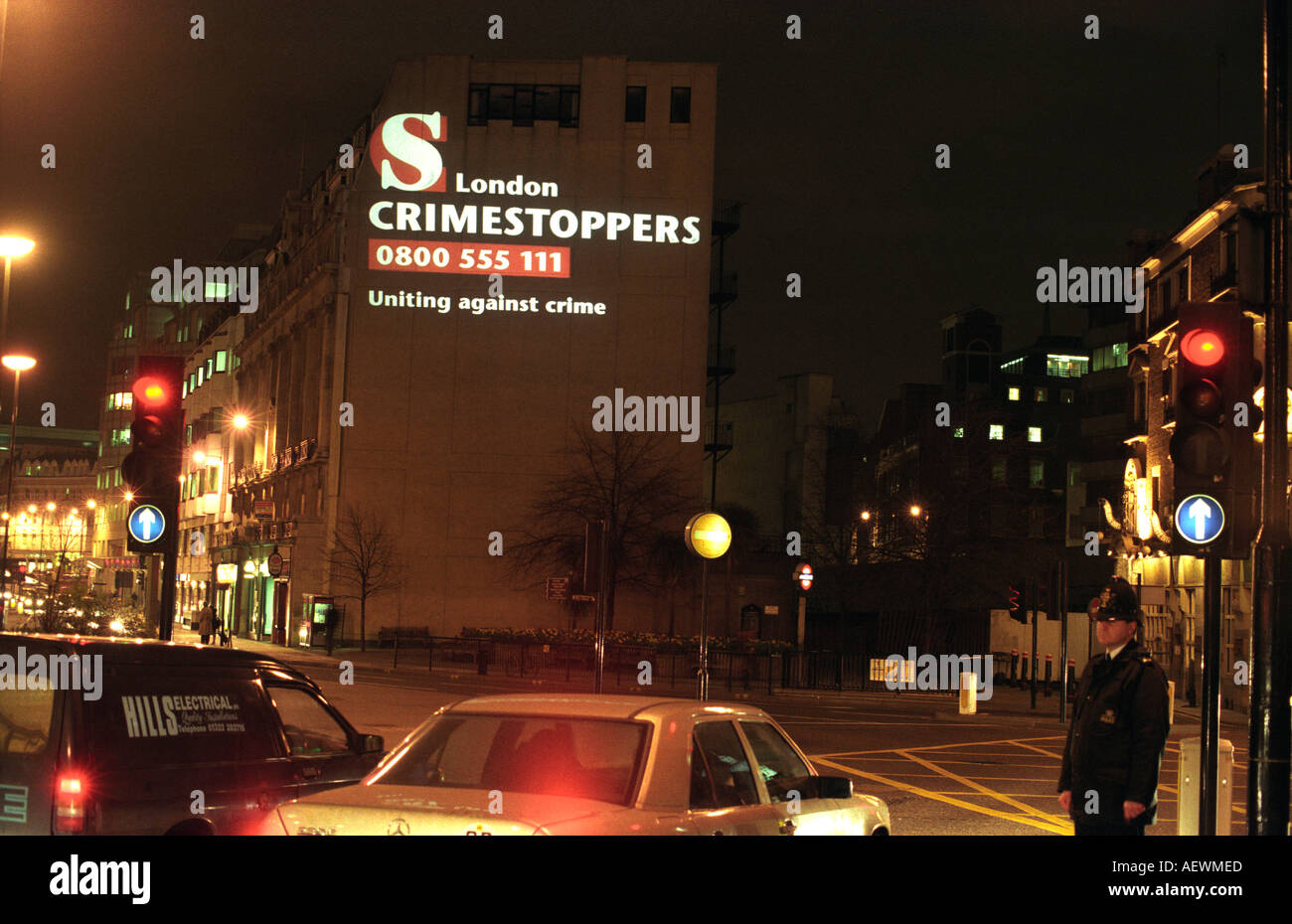 Crimestoppers logo beamed onto wall at night in London UK Stock Photo