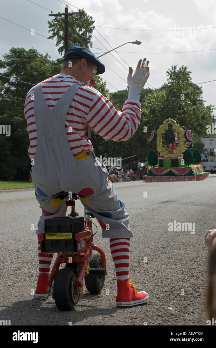 Parade clown on a mini scooter. Stock Photo