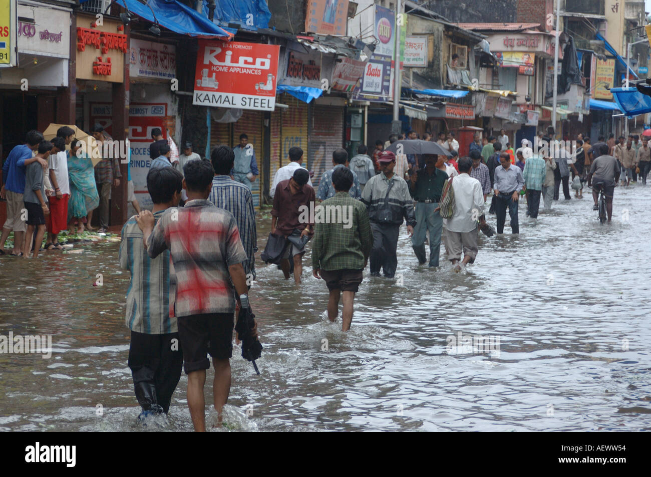 People walking in flooded street after monsoon rain in Mumbai India ...