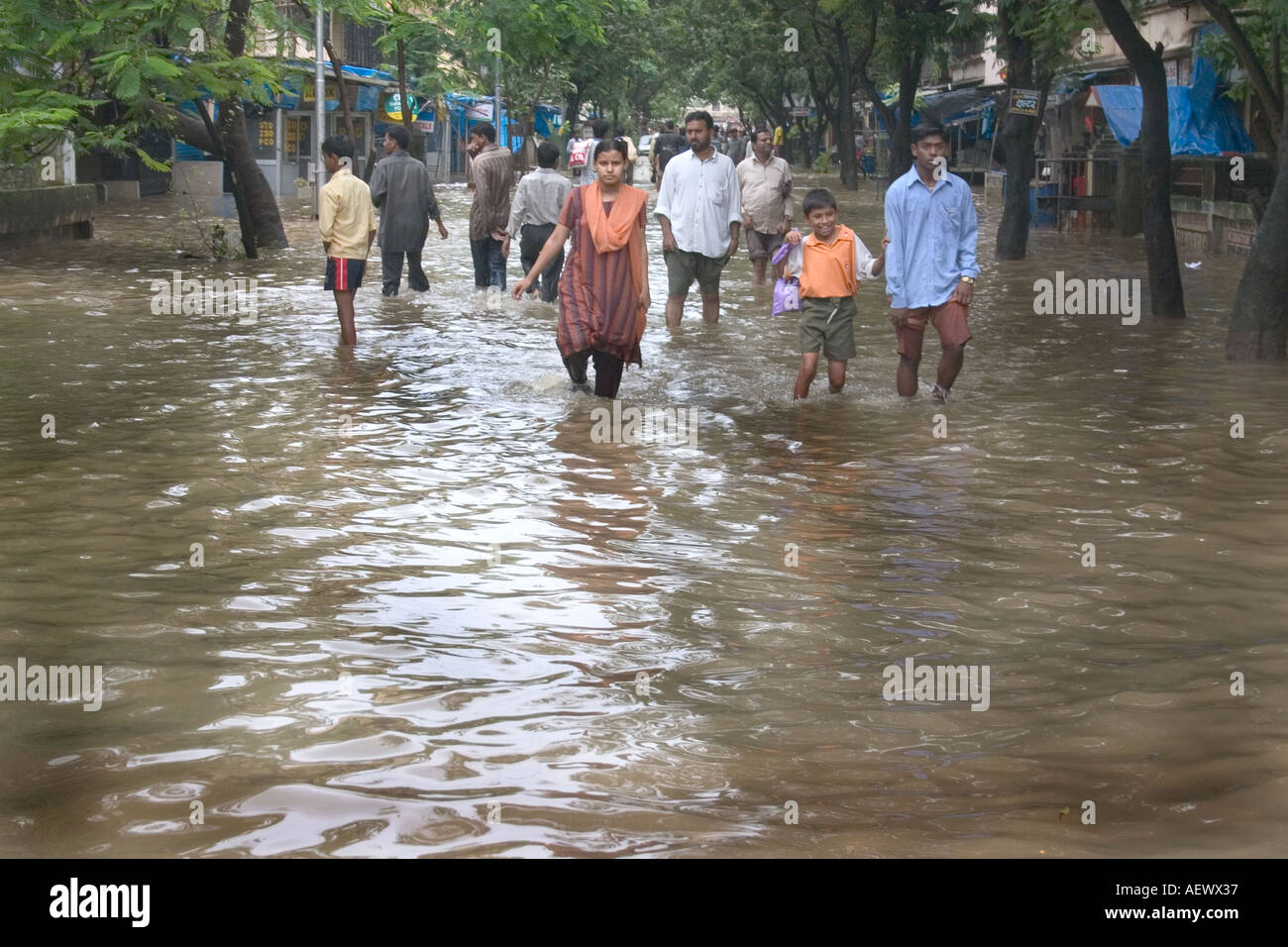 people walking in monsoon rain flooded street in Bombay now Mumbai ...
