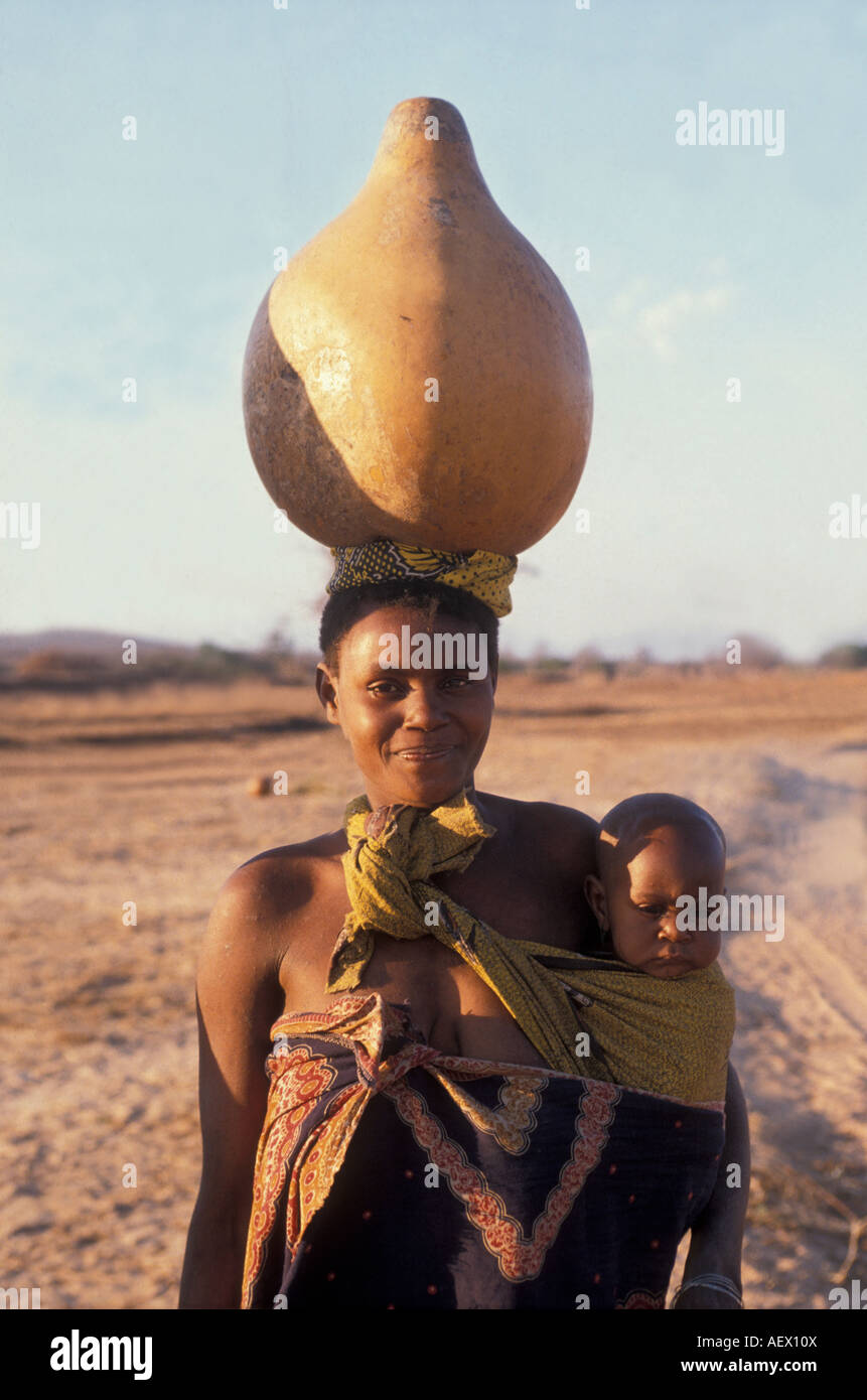 Woman carrying water in a calebasse, Dodoma district, Tanzania. Stock Photo