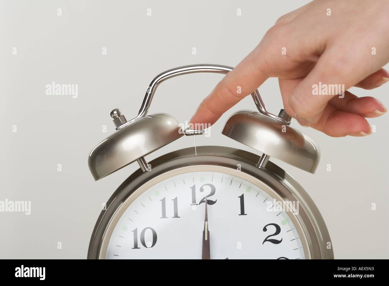 Aex5n3 woman turning off alarm clock hires stock photography and