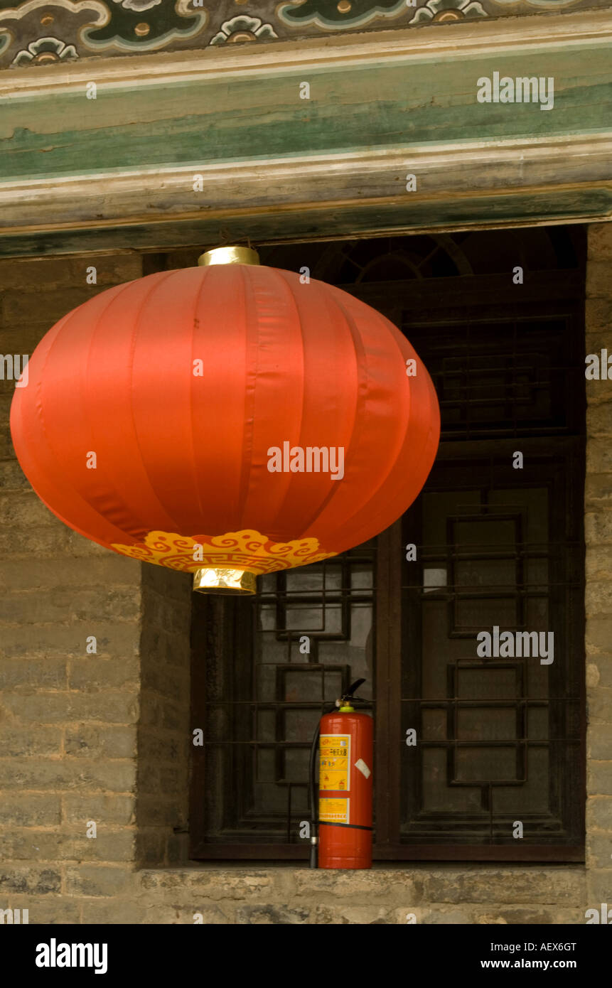 Just in case! Chinese lantern and fire extinguisher in shuttered window behind, on the City